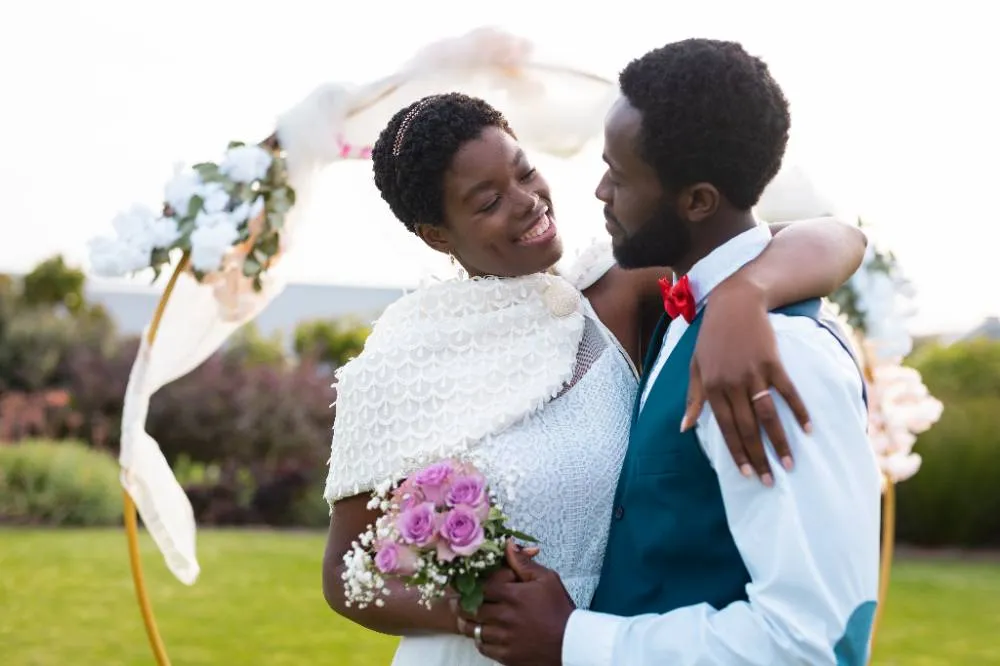 Happy African American Couple Embracing And Smiling