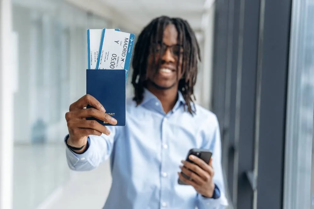 Showing The Tickets Male Tourist Is In The Airport