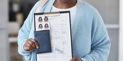 Woman reviewing travel documents at a desk