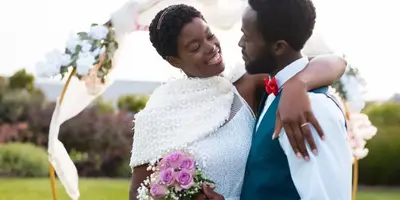 Couple embracing and smiling at a destination